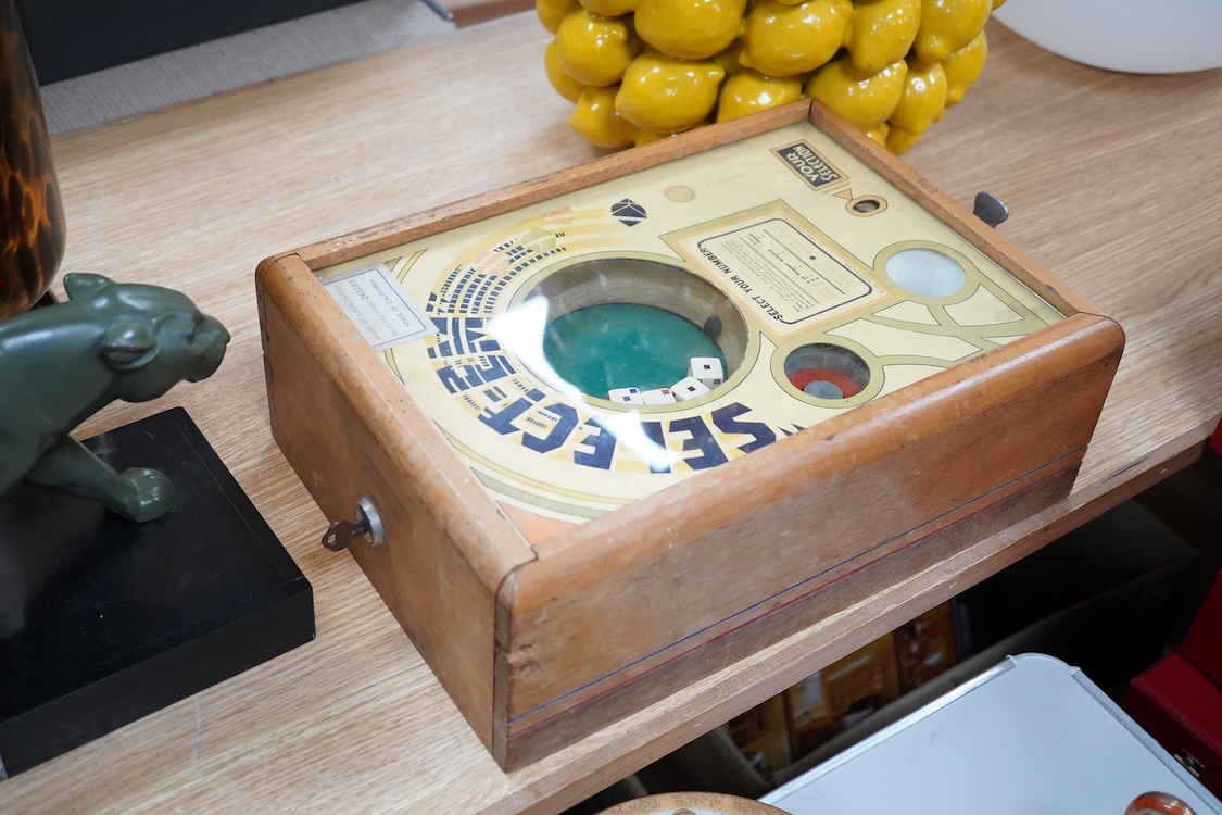 A ‘Select-Em’ table top pinball style dice game in a teak frame dated 1933, with Board of Equalization sales tax permit label for the State of California, 26cm wide, 35.5cm deep, 12.5cm high